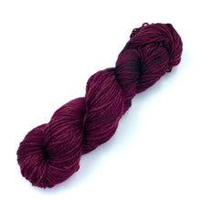 Load image into Gallery viewer, Skein of superwash merino yarn hand dyed in a red wine color

