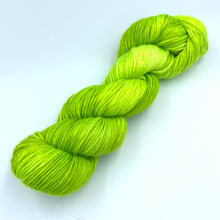 Load image into Gallery viewer, Skein of superwash merino yarn hand dyed in a lime green color
