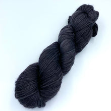 Load image into Gallery viewer, A skein of sparkly wool and nylon yarn hand dyed in the color charcoal black
