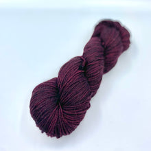 Load image into Gallery viewer, Skein of superwash merino yarn hand dyed in a red wine color
